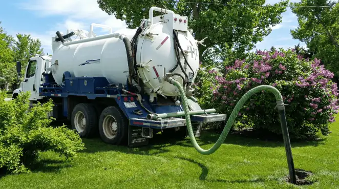 Professional vacuum truck performing residential drainage and septic maintenance in Richmond, VA